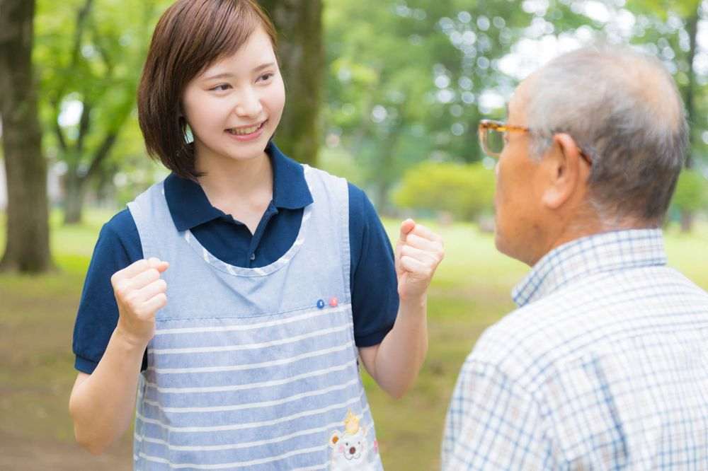 男性に笑顔で声をかける介護スタッフ